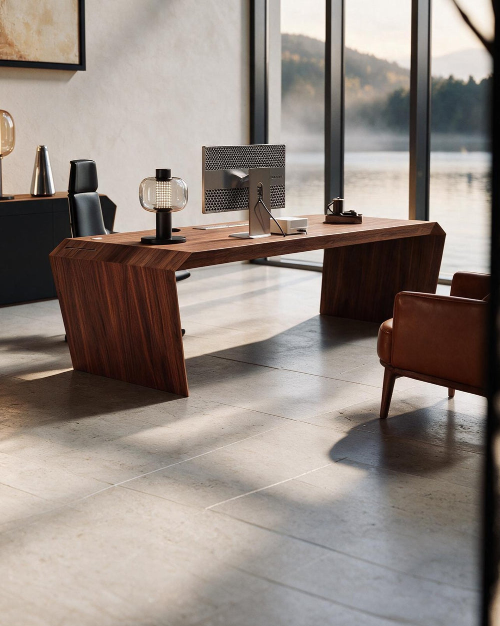 EDELHOLZ DeskPRO Schreibtisch in Deep Walnut, Seitenansicht mit Monitor, Tischleuchte und Sessel im lichtdurchfluteten Büro [finish:deep-walnut]